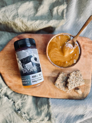 Steens Manuka Honig MGO 400+ in einer Schüssel mit Löffel und Brot