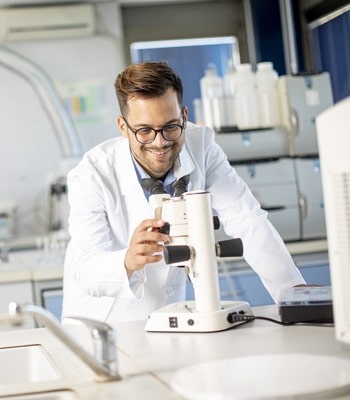 Wissenschaftler im Labor vor einem Mikroskop
